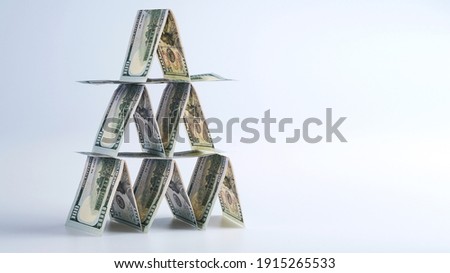 100 us dollar bills lined up in house of cards, money banner concept, financial pyramid, ponzi scheme, affaire, hustle, crook business