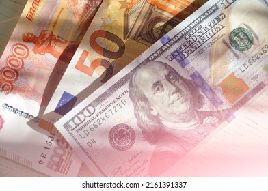 100 US Dollars Banknote Next To 50 Euros And 5000 Russian Rubles. World Currencies. Euro Trading With Dollar And Russian Ruble.