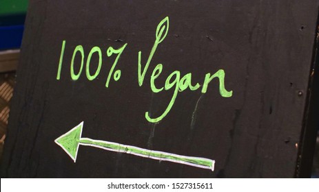 100% Vegan Chalk Sign With An Arrow Pointing To The Left. The Sign Is To Attract Non-meat Eaters To The Eatery, Vegan Is Healthy, Clean Eating No Dairy No Meat. 