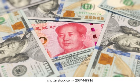 100 Yuan Banknote Among 100 US Dollar Banknotes 