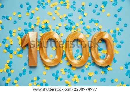 1000 one thousand followers subscriber card golden birthday candle on yellow and blue confetti Background. Template for social networks, blogs. celebration banner. 1000 online community fans.