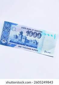 The 1,000 Pak Rupee note features Quaid-e-Azam on the front and Islamia College, Peshawar on the back. It includes security features like a watermark and color shift ink prevent counterfeiting.