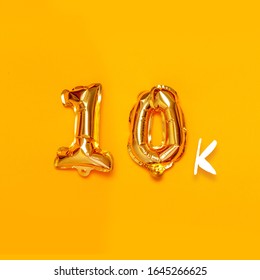 10,000 Gold Sign Balloon On A Yellow Background. Subscribe Concept. Holiday Poster For Banner, Poster