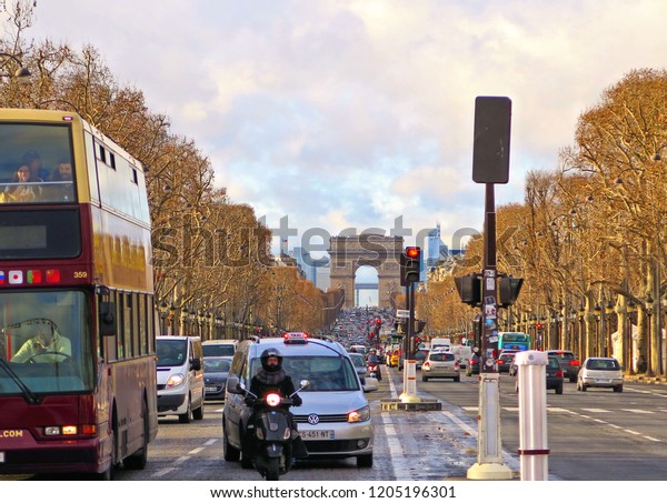 10.01.2015. Traffic stopped at the traffic light\
in Famous Champs-Elysees and Arc de Triomphe in background in\
Paris, France                           \
