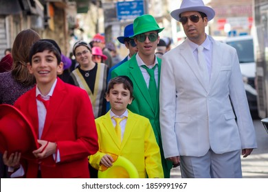 10/03/2020 Jerusalem, Israel: A Jewish Family Wearing Suits In A Variety Of Colors On Purim