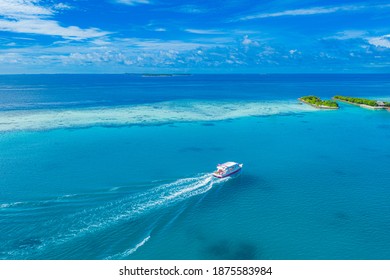 10.08.19, Maldives: Aerial view sailing boat next to reef. Bird eye view, water sport theme. Snorkel excursion, recreational dive with tourist. Luxury water sport diving activity in Maldives