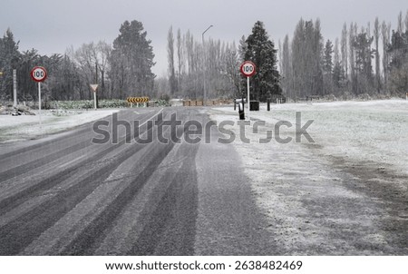 100kmh road sign in the heavy snowfall. Ashburton Lakes. South Island. 