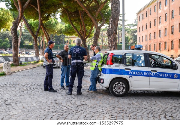 10.10.2019 Rome, Italy. Police officers talking to\
the patrol car
