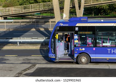 10/13/2019 Portsmouth, Hampshire, UK A Bus Driver At The Wheel Of His Bus Waiting At A Bus Stop