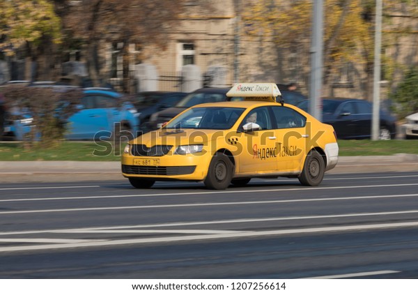 10/19/2018 Russia, Moscow. The city\
taxi of Taxi Yandex goes down the street in the afternoon\

