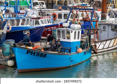 10/20/2020 Portsmouth, Hampshire, UK Two Fishermen Talking On A Fishing Trawler That Is Docked On A Quayside