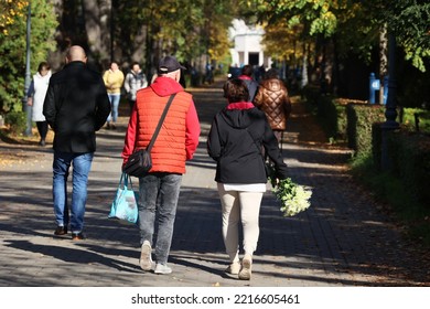 10.20.2022 Wroclaw, Poland, Older People Are Walking Down The Autumn Alley In The Cemetery.