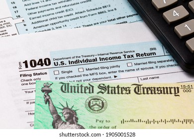 1040 Individual Income Tax Return Form And Tax Refund Check. Concept Of Filing Taxes, Taxable Income And Tax Information.