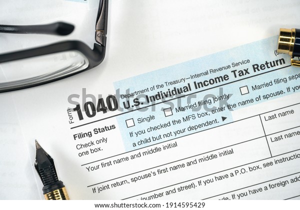 1040 Tax Form. Tax\
Payment Concept. Filing Taxes Document on Table in Office.\
Individual Income Tax\
Return