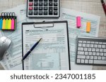 1040 tax form with pen and calcultor on desk, paperwork and accounting conept