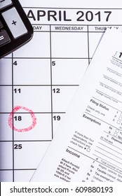 1040 Tax Return With Calender And The 18th Circled In Red