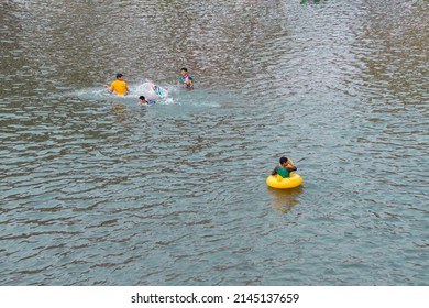 10-APRIL-2019 - Songkran Day, people come to have enjoying at the Ping River. Kamphaeng Phet Province, Thailand. Children swimming.