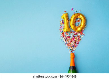 10th anniversary champagne bottle balloon pop - Shutterstock ID 1644934849