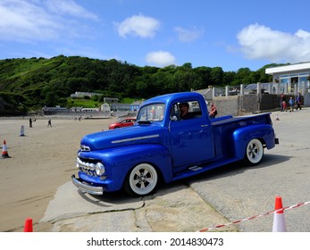 10th July 2021- A Stylish 1950's Ford F Series Pick-up Truck Being Driven Onto The Sandy Beach At Pendine, Carmarthenshire, Wales, UK.