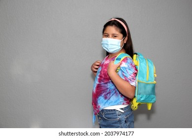 10-year-old Hispanic Girl With Backpack And Mask Ready To Return To School In The New Normal Due To The Covid-19 Pandemic
