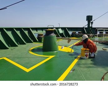 11 August 2021 At Mediterranean Sea. A Ship Crew Is Painting On Deck Of A Cargo Ship During Maintenance Period.