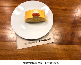 11 May 2019; Bangkok Thailand: Top View Of Dish Of Starbucks Orange Roll Cake Dessert At Starbucks Coffee Shop