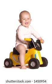 11 moths old baby rides a toy motorbike and he really enjoys it.