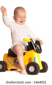 11 moths old baby rides a toy motorbike and he really enjoys it.