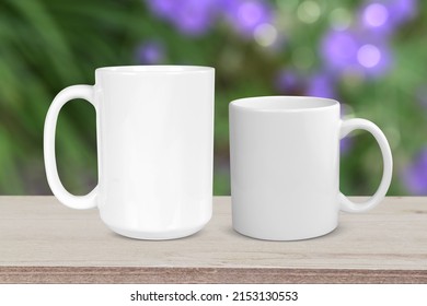 11 Oz Coffee Cup And 15 Oz Coffee Cup Relaxing On A Rustic Light Wood Tabletop With A Pretty Floral Garden In The Background.