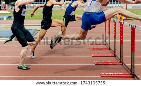 110 meter hurdles man runners running for athletics competition