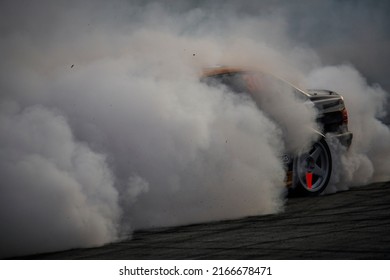 11-05-2022 Riga, Latvia Car Drifting On Asphalt Racing Track With Lot Of Smoke, Motion Blur Drift Car..