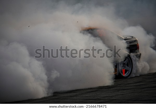 11-05-2022 Riga, Latvia\
car drifting on asphalt racing track with lot of smoke, motion blur\
drift car..