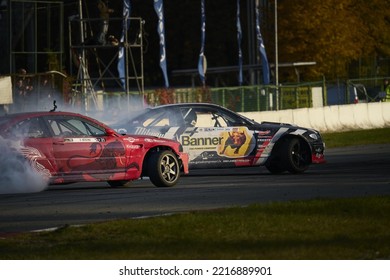 11-05-2022 Riga, Latvia A Couple Of Cars That Are On A Race Track, Two Sports Cars Racing Each Other In A Race.