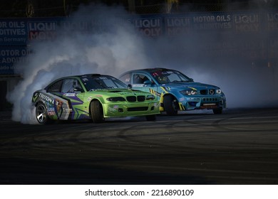 11-05-2022 Riga, Latvia A Couple Of Cars That Are On A Track, Two Cars On A Track Racing Through The Smoke.