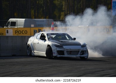 11-05-2022 Riga, Latvia A White Car With Smoke Coming Out Of It, A Modified Drift Car With A Smoke Trail Coming From The Exhaust Pipe.