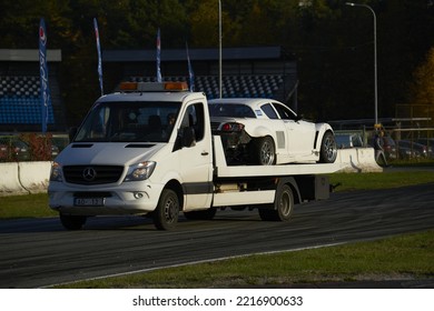 11-05-2022 Riga, Latvia A White Truck Driving Down A Race Track, A White Truck Driving On A Road Near A Race Track.