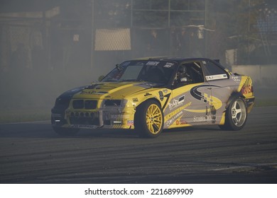 11-05-2022 Riga, Latvia A Yellow And Gray Car Driving On A Track, A Man In A Yellow Car Racing On A Track.