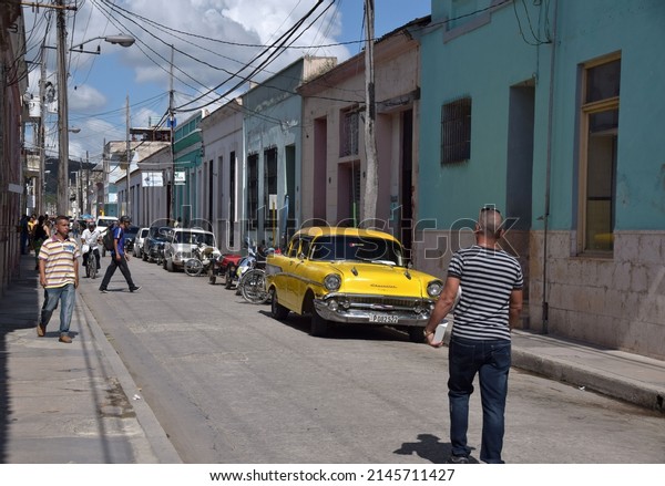 11.23.2015, Santiago de Cuba. Street scene and\
parked colorful vintage American car in Cuba\'s second biggest city\
of Santiago de Cuba,\
Caribbean.