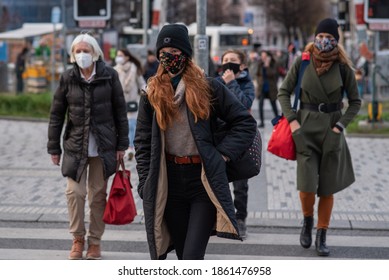 11-23-2020. Prague, Czech Republic. People Walking And Talking Outside During Coronavirus (COVID-19) At Hradcanska Metro Stop In Prague 6. Woman With Mask Crossing..