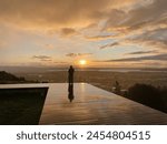 12 August 2023: Sunset with light reflecting on a wet boardwalk, Mount Eden summit, Auckland, New Zealand