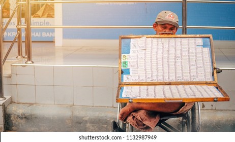 12 July 2018 , Chatuchak Market In Bangkok , Old Asian Man With Disabilities Disabled A Person With Differently Abled Sitting In A Wheelchair Waiting Customer To Buy Thai Lottery Ticket .