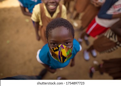 12 June 2020| Accra Ghana | An African school child with colourful pattern print nose mask . Protection against COVID 19. Rural underprivileged children in Ghana, Africa . 