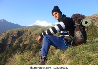 12 June 2021, Chamoli, Uttarakhand, India. A Local Trek Guide From Himalaya Region Posing For A Photo With His Backpack During A Trek In Himalaya. 