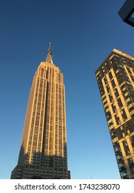 12 October 2017 - New York City: Looking up at the Empire State Building at the golden hour, warm light illuminates the iconic Art Deco skyscraper in midtown Manhattan built in 1931.
