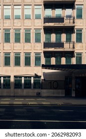 12 Sep 2021 - London\uk: Facade Of 1980s Office Building With Balconies On Empty Street Under High Contrast Shadowing Cast Over The Exterior On Sunny Day