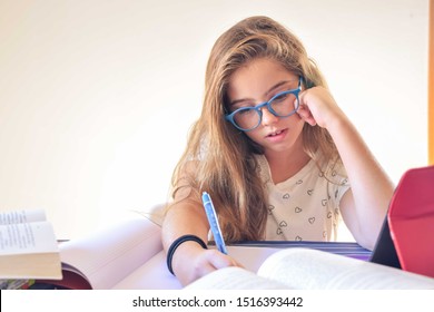 12 Year Old Girl Studying And Doing Homework At Home