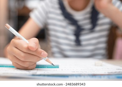 12 year old girl studying at home - Powered by Shutterstock