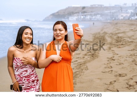 120 characters exactly let's count, two smiling young women on a sunny beach taking a selfie with a smartphone, enjoying vacation, friendship and summer vibes count, i'll trust it's around 120