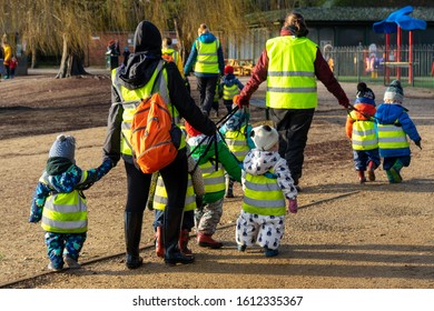 12/09/2019 Portsmouth, Hampshire, UK A Group Of Young Children Walking Through A Park As A Group Wearing High Visibility Vests 