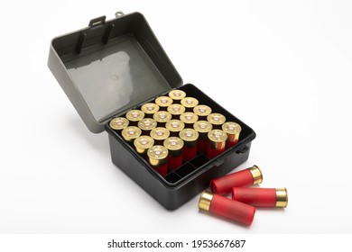 12-gauge shotgun bullet shells and plastic box on white background
